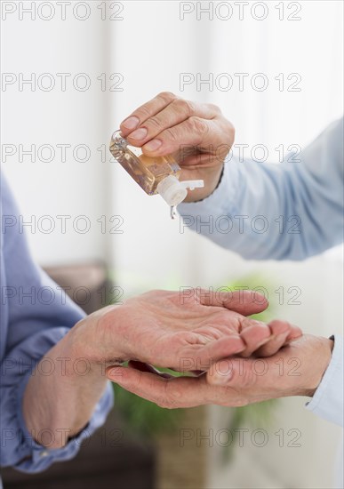 Front view women using hand sanitizer