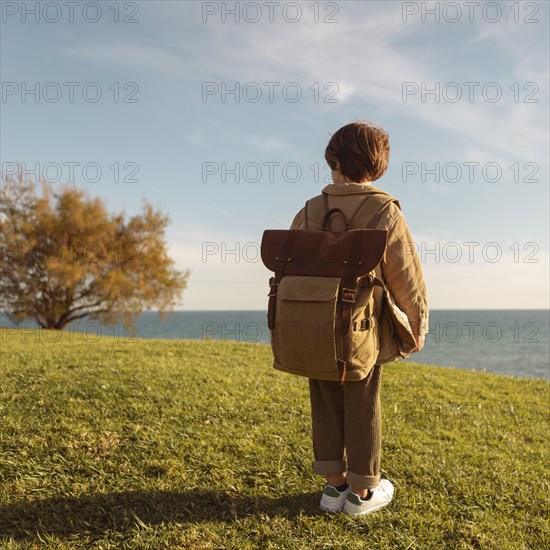 Full shot boy wearing backpack