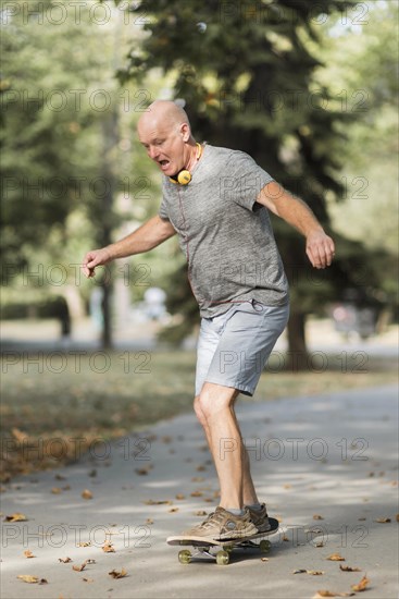 Full shot man with skateboard park