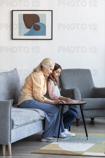 Full shot woman girl living room