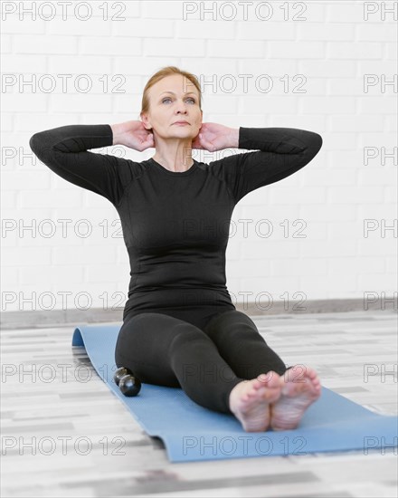 Full shot woman sitting mat