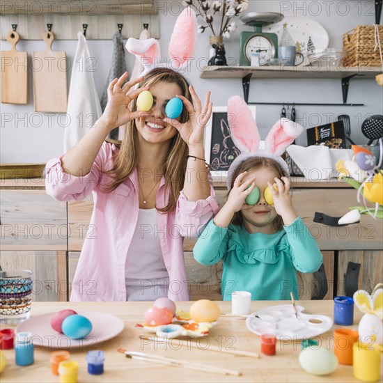 Girl mother holding easter eggs eyes