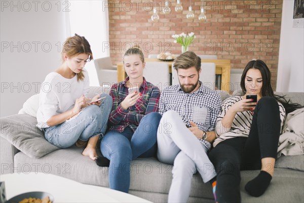 Group people using gadgets sofa