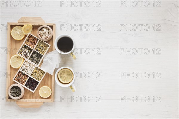 Herbs dried chinese chrysanthemum flowers with lemon slices wooden tray