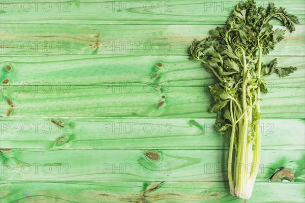 High angle view fresh celery green wooden background