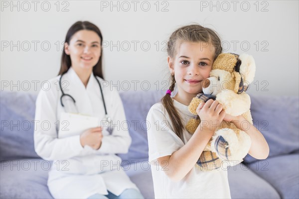 Ill girl being examined by doctor