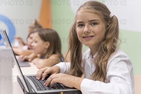 Kids using laptop school