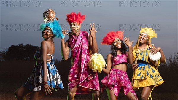 Low angle group friends dressed carnival