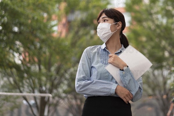 Low angle woman with face mask concept