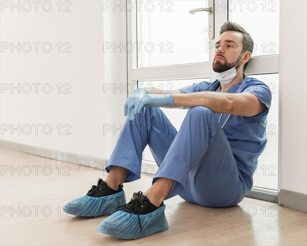 Male nurse tired after long day work