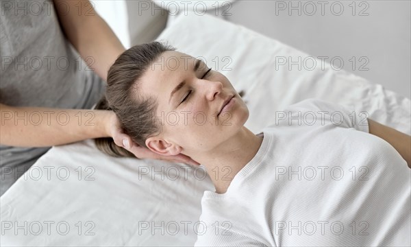 Male therapist undergoing physical therapy with female patient