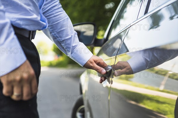 Man s hand opening car door