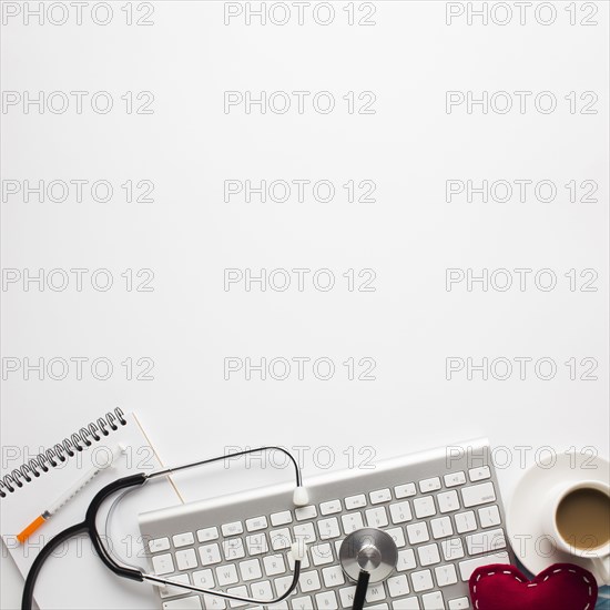 Medical tool cup coffee with stitched toy heart isolated white background