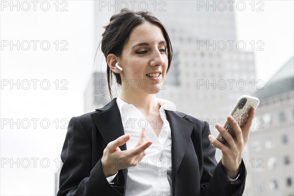 Medium shot business woman with airpods