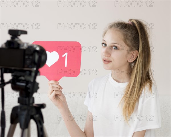 Medium shot girl with video camera