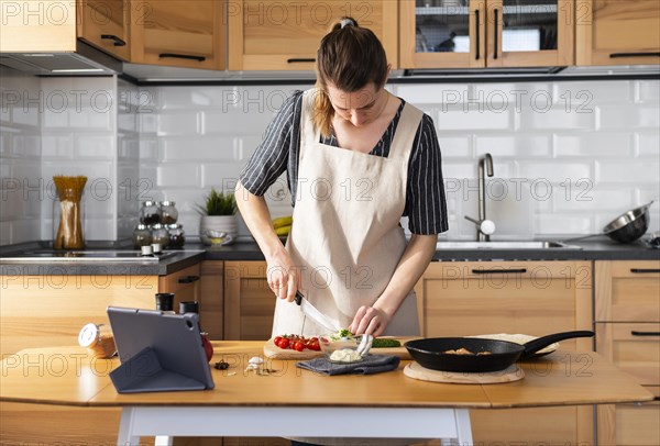 Medium shot woman cooking home