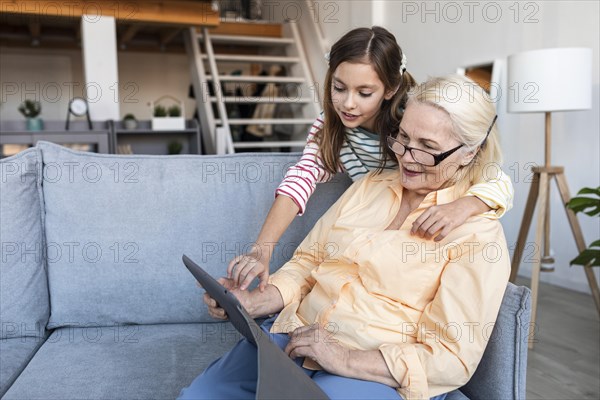 Medium shot woman girl with tablet