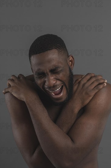 Naked man screaming looking down