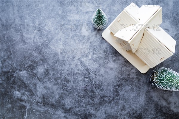 Overhead view house model with christmas tree weathered concrete background