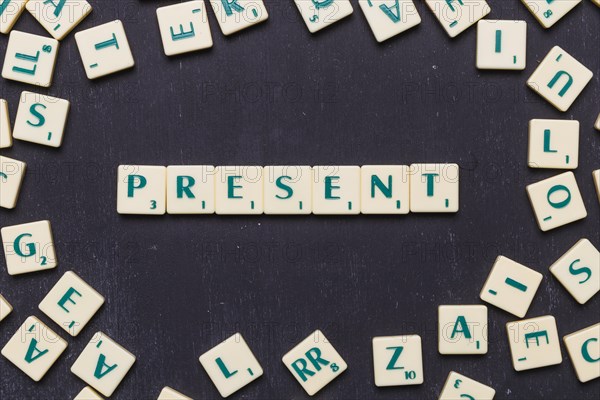 Overhead view present text scrabble letters black backdrop