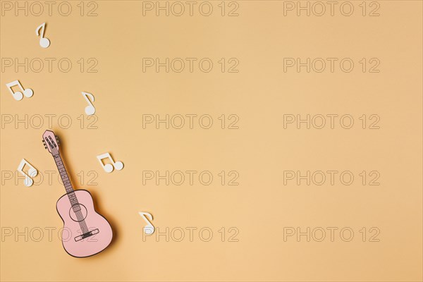 Pink guitar with white musical notes