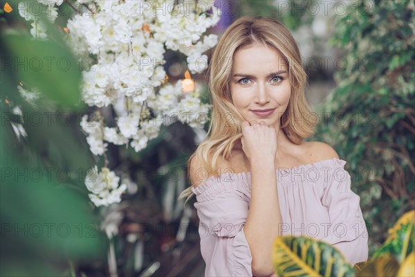 Portrait pretty blonde young woman standing lush