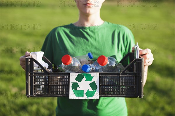Recycle background with woman holding box