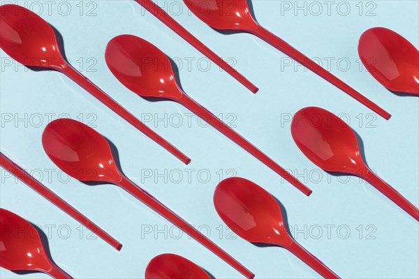 Red plastic spoons top view