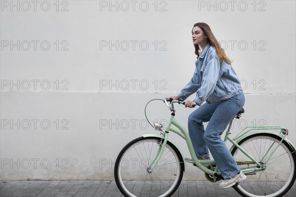 Side view woman riding her bike