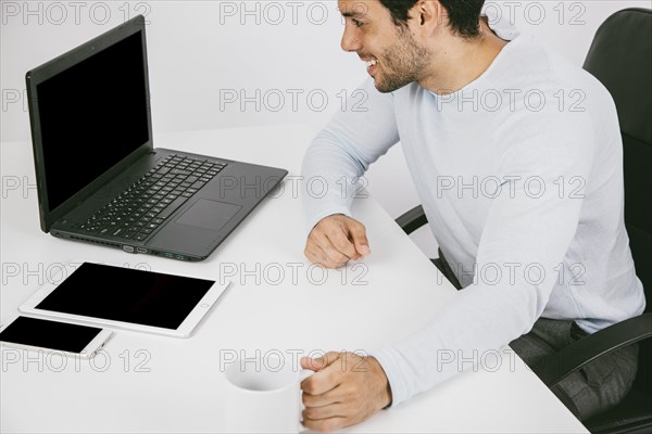 Smiley man with technological devices coffee mug