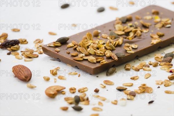 Spread dried fruits chocolate bar against white backdrop