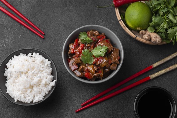 Top view asian dish with rice chopsticks