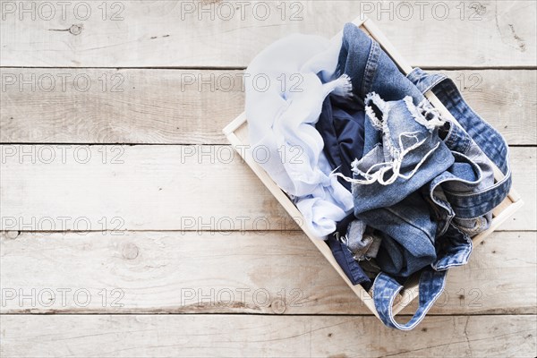 Top view full laundry basket with wooden background