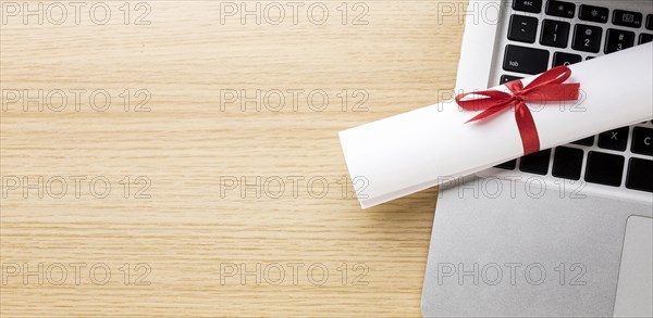 Top view laptop with diploma