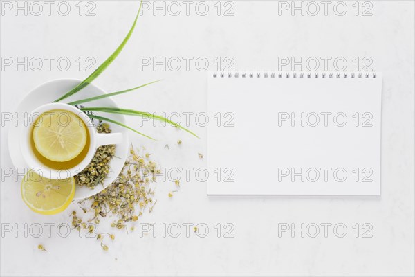 Top view lemon tea with notebook