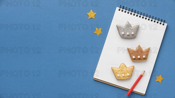 Top view notebook with three crowns stars epiphany day