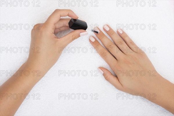 Top view woman applying nail polish