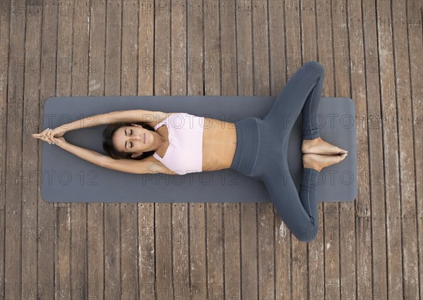 Top view woman doing yoga outdoors