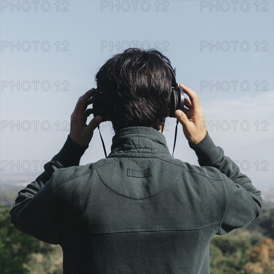 Unrecognizable man listening music