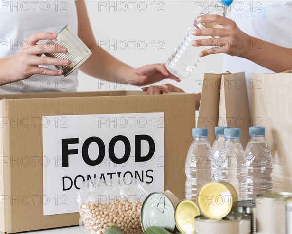 Volunteers with box water bottles donation