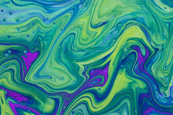 Wavy green violet fluid acrylic pour painting