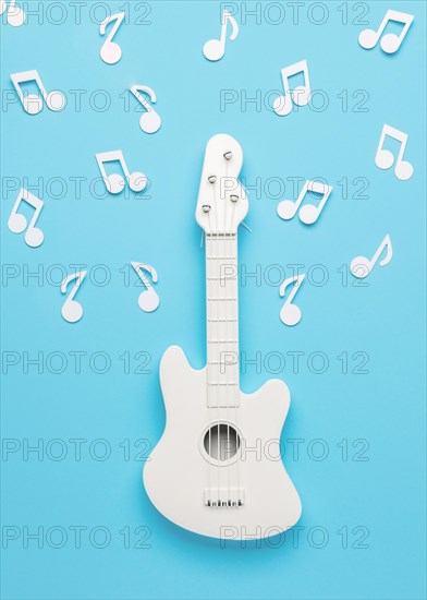 White guitar with musical notes
