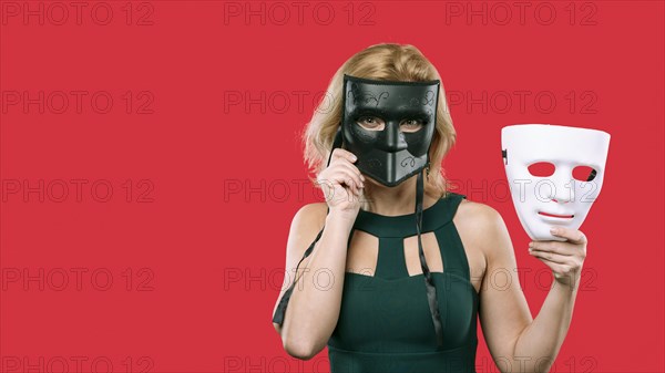 Woman covering face with black mask