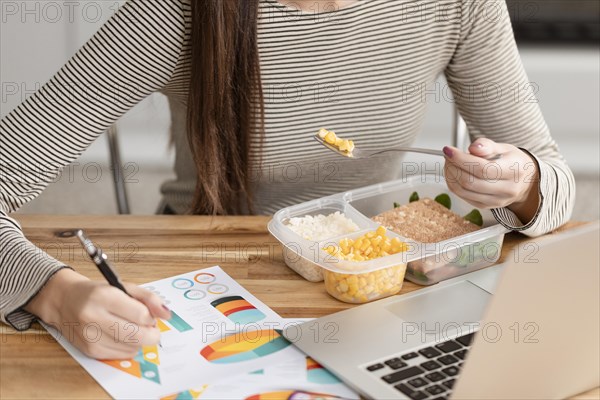 Woman eating working from home