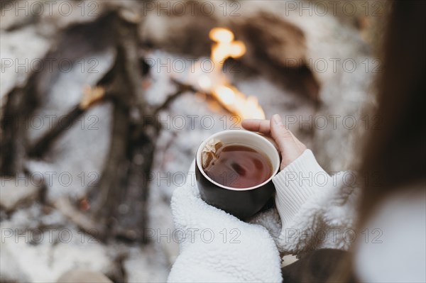 Woman holding hot cup tea