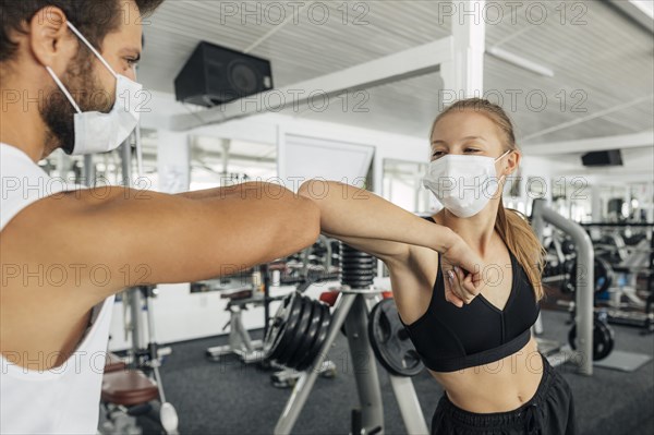 Woman man doing elbow salute gym