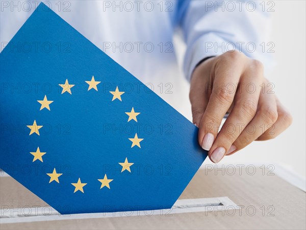 Woman putting european union envelope box