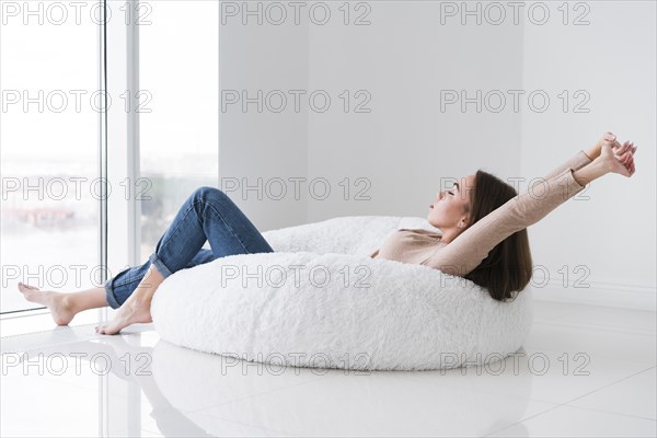 Woman relaxing looking through window