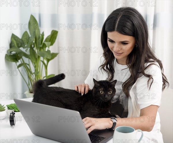 Woman working as lancer playing with cat