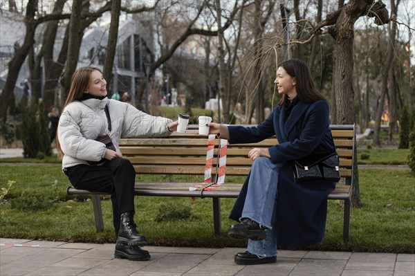 Women sitting distance wearing mask